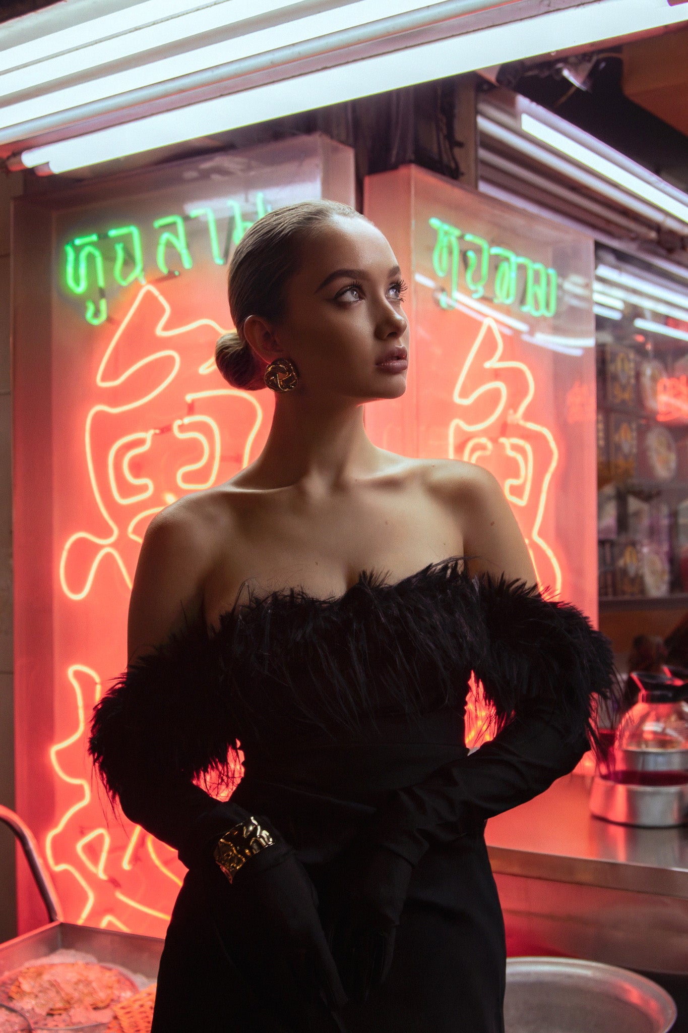 Woman in a black dress standing in front of a neon sign. Bangkok Night Chinatown Photoshoot by Photographer Nadya Shell